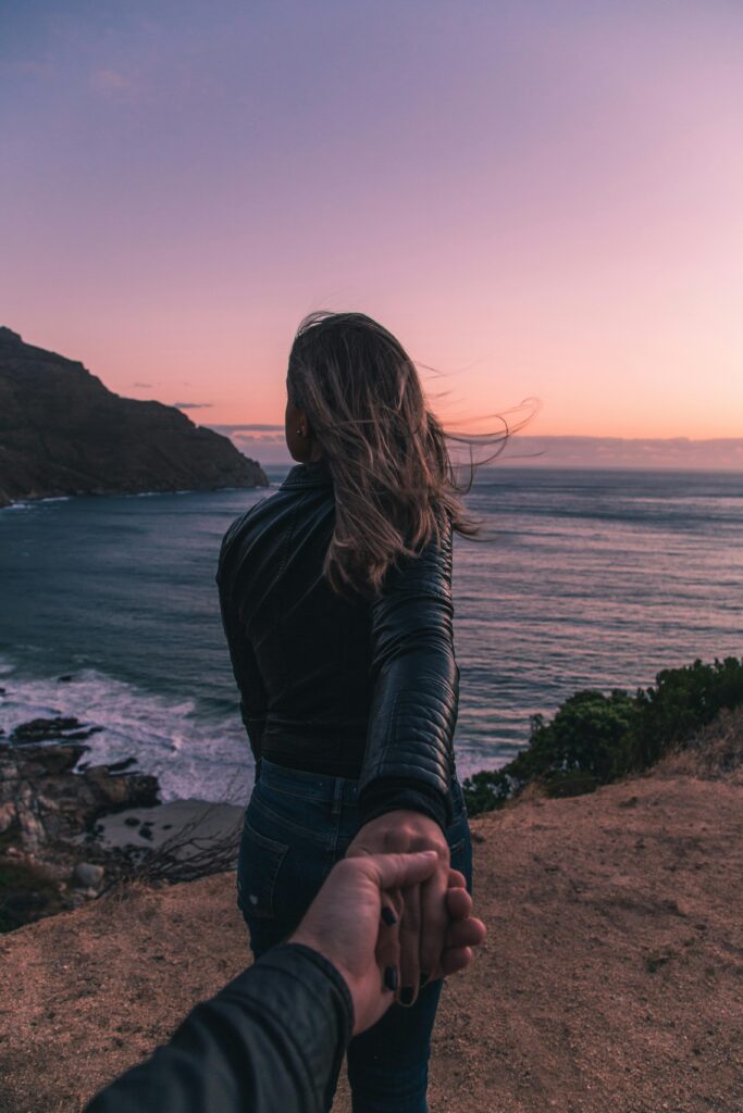 pexels photo 2379179 2379179 Young couple holding hands by the ocean with a stunning sunset view in Cape Town.